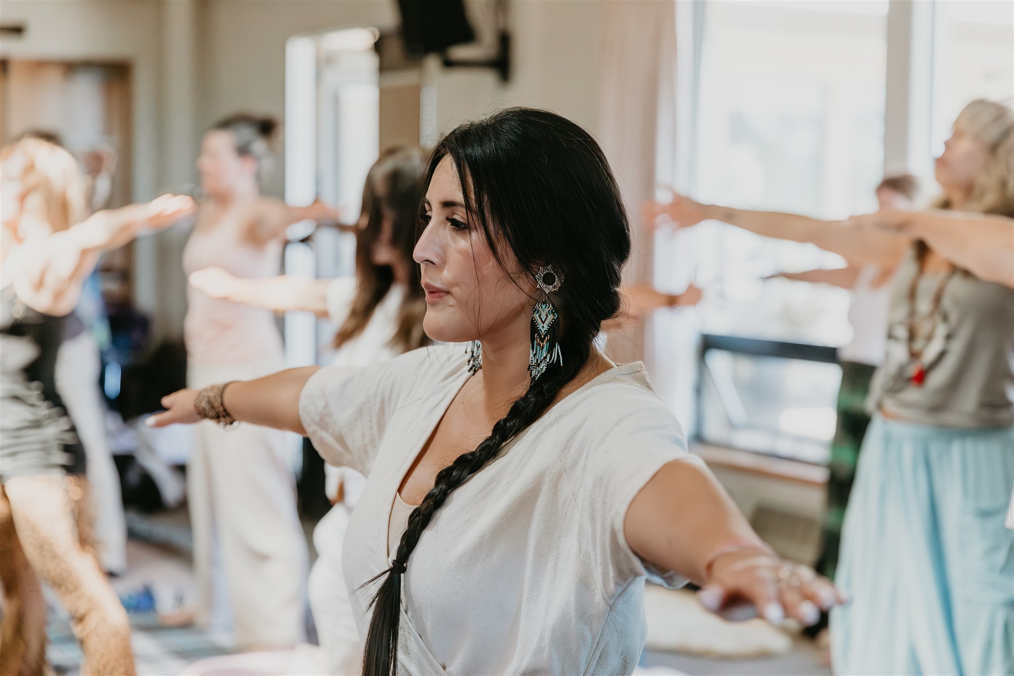 Woman centered with arms open overhead in devotional practice